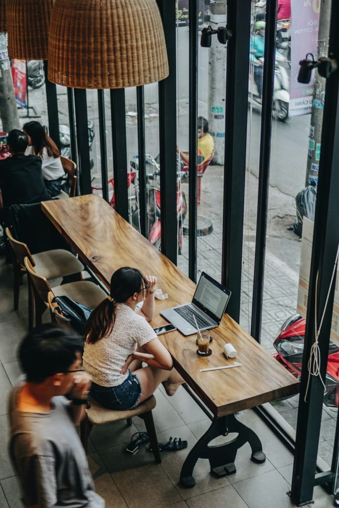 a-couple-of-people-sitting-at-a-table-with-laptops-vcg7pklkgvm